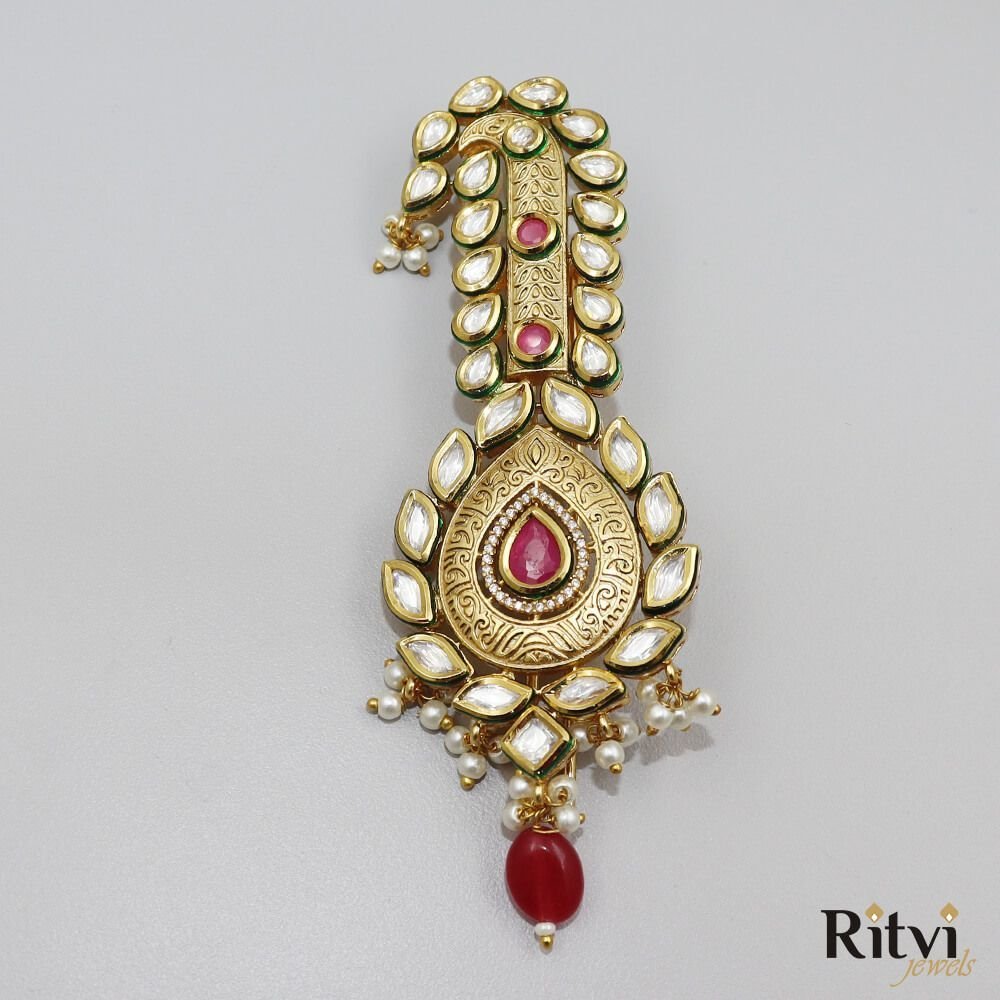 Ritvi-Akshay-Gold-Finished-Pearl-Kundan-Kalgi-Ruby-1.jpg Akshay Gold Finished Pearl Kundan Kalgi Ruby - Image 1